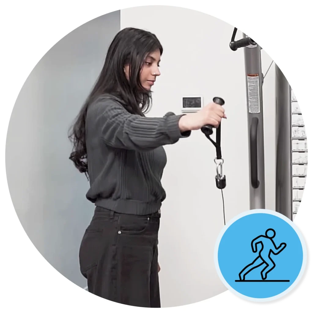 A Smart Motion Physiotherapy patient uses a cable pulley machine during an active rehabilitation exercise session.
